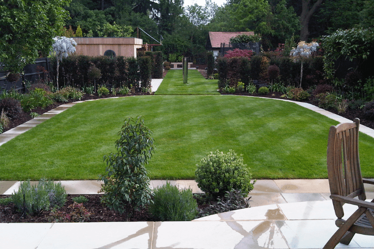 manicured lawn with path around the edge and plants