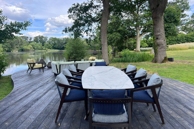 deck near pond with outdoor seating