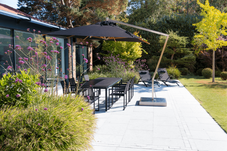 Poolside terrace with outdoor dining and seating, designed to connect swimming pool, garden planting and the house