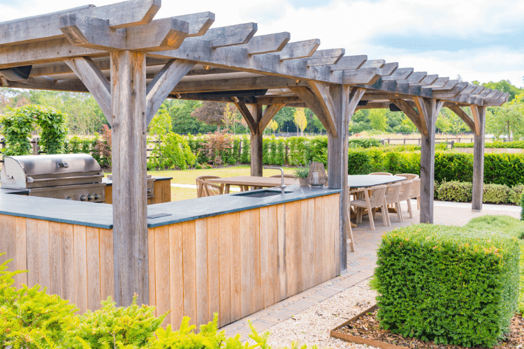 wooden pergola over outdoor kitchen