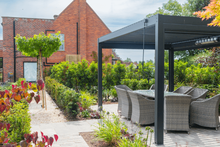landscaped garden with pergola with dining area