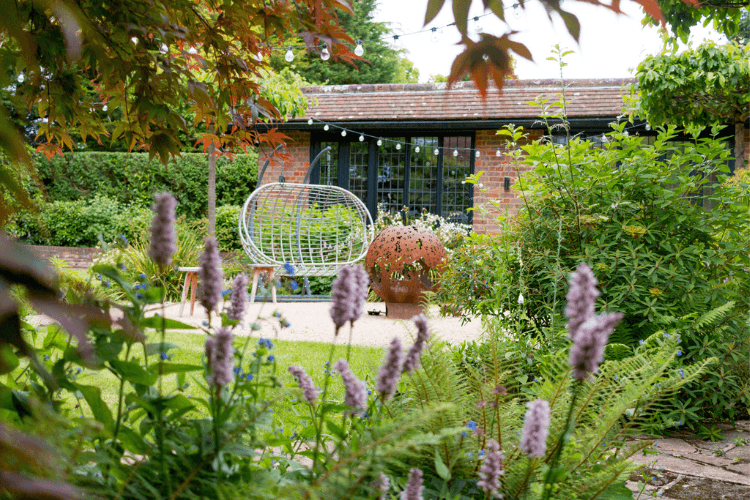 Layered planting scheme in a contemporary garden designed for atmosphere, privacy and seasonal interest